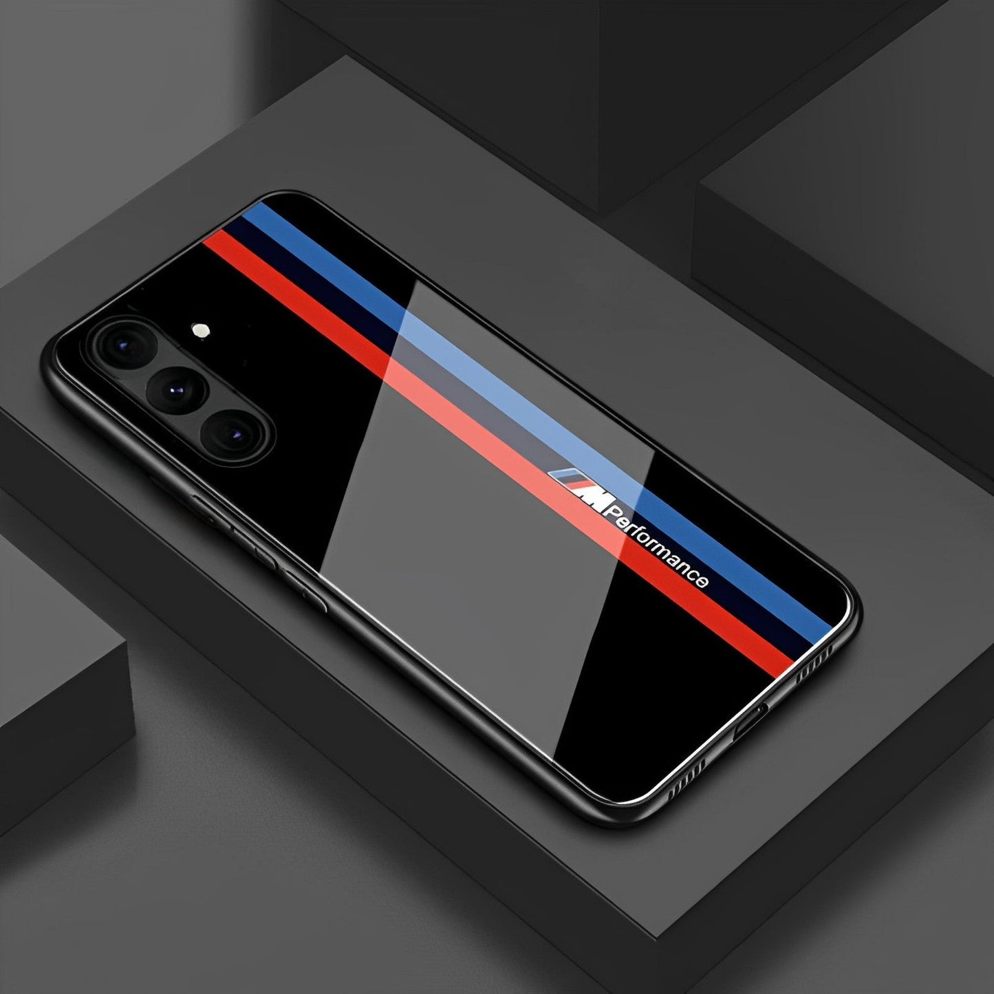 A Samsung Galaxy A34 5G smartphone case with a BMW performance design, featuring a black glass back with blue and red stripes.